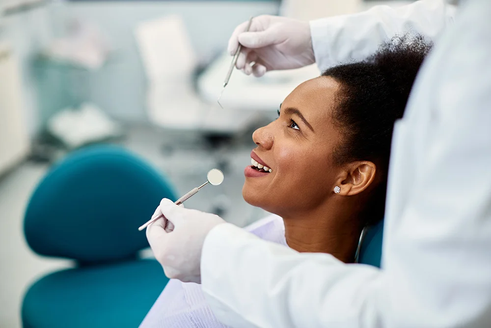 Happy black woman having dental health examination at dentist's office.