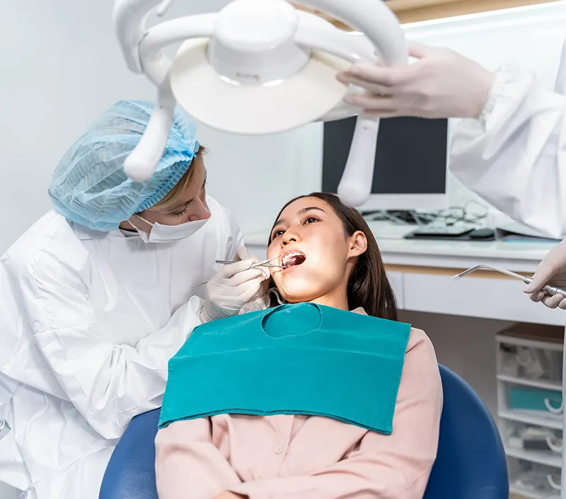 Orthodontist doctor examine tooth to woman patient at dental clinic. Infection control standards