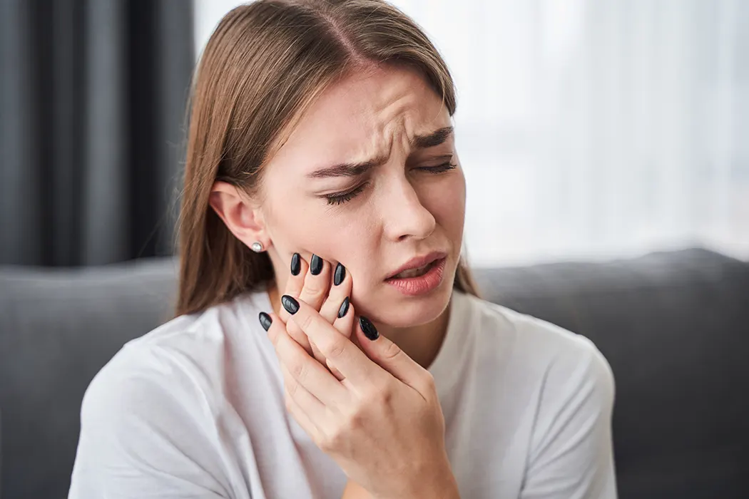 Frustrated young women suffering from toothache on wisdom teeth